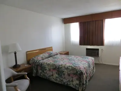 a hotel room with a bed and a chair at Jet Inn in Los Angeles