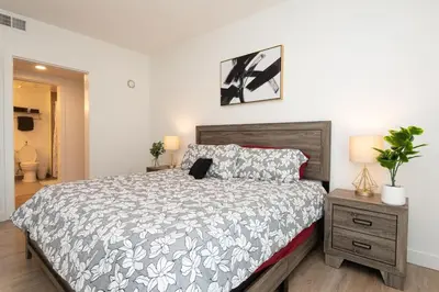 a bedroom with a bed with a laptop on it at Comfy Apt with pool & hot tub in downtown LA 658 in Los Angeles