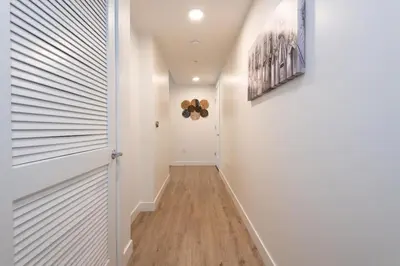 a hallway with white walls and a white door at Comfy Apt with pool & hot tub in downtown LA 658 in Los Angeles