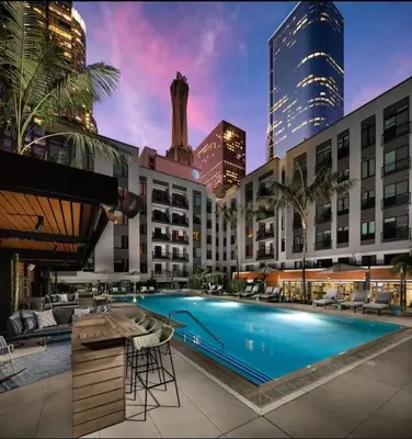 a large swimming pool in a city with buildings at Comfy Apt with pool & hot tub in downtown LA 658 in Los Angeles