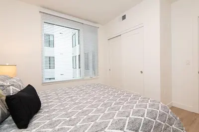 a bedroom with a bed and a window at Comfy Apt with pool & hot tub in downtown LA 658 in Los Angeles