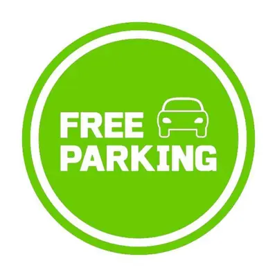 a green free parking sign with a car in a circle at NYC Styled Loft In DTLA, sleeps 4 with Free Parking! in Los Angeles
