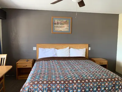 a bedroom with a bed and a ceiling fan at Cinderella Motel in Wasco