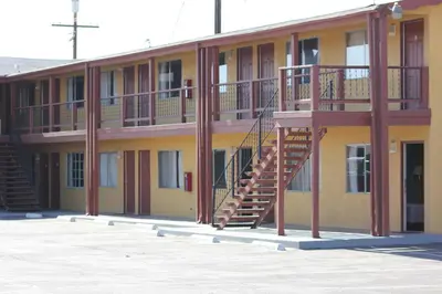 a building with a staircase on the side of it at Cinderella Motel in Wasco