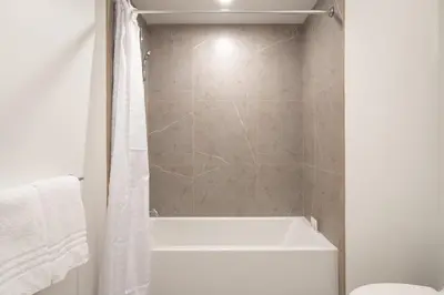 a bathroom with a shower with a tub and a toilet at Level Hollywood in Los Angeles