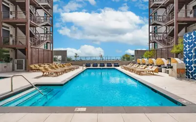 a swimming pool at a hotel with chairs at Level Hollywood in Los Angeles