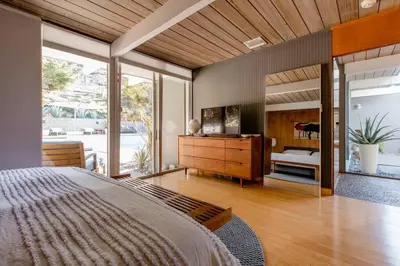 a bedroom with a large bed and a large window at Eichler Mid Century Modern Designer Pool/Jacuzzi in Thousand Oaks