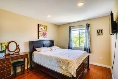 a bedroom with a bed and a dresser and a window at Westminster Apartment Near Beaches and Theme Parks! in Westminster