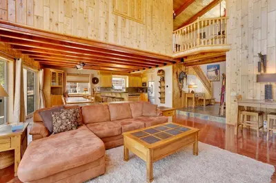 a living room with a couch and a table at Lakefront Village Castle- Foosball- Boat Dock- in Big Bear Lake