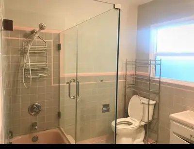 a bathroom with a toilet and a glass shower at Room in Monterey Park CA in Monterey Park