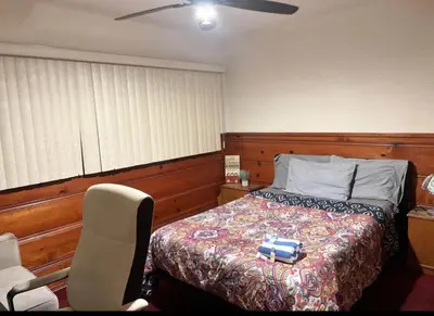 a bedroom with a bed and a chair in it at Room in Monterey Park CA in Monterey Park