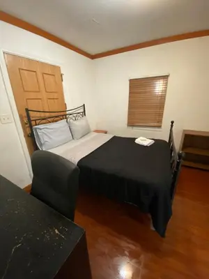 a small bedroom with a bed and a window at House Rooms & RV Rooms Near LAX in Los Angeles