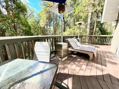 a deck with chairs and a table on a house at Family Friendly A Frame, Pets stay Free! in Lake Arrowhead