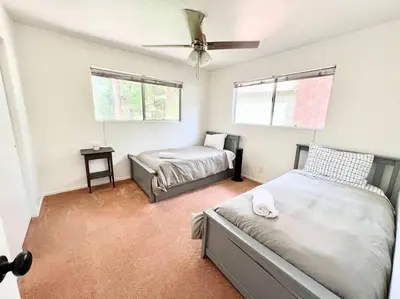 a bedroom with two beds and a ceiling fan at Family Friendly A Frame, Pets stay Free! in Lake Arrowhead