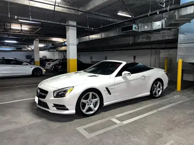 a white car parked in a parking garage at Downtown Los Angeles Skyline balcony view Modern Penthouse in Los Angeles