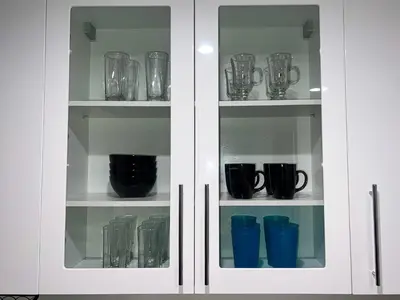 a cabinet filled with cups and vases on shelves at Downtown Los Angeles Skyline balcony view Modern Penthouse in Los Angeles