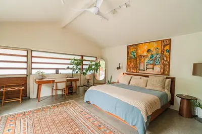 a bedroom with a bed and a desk and a table at Casa Superba - Peaceful Sanctuary in Venice in Los Angeles
