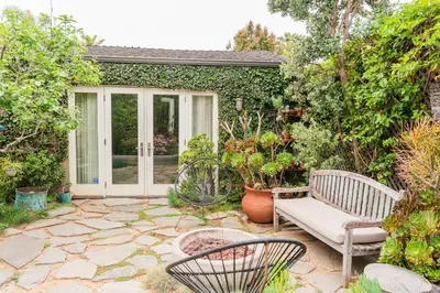 a patio with a bench and some plants at Casa Superba - Peaceful Sanctuary in Venice in Los Angeles