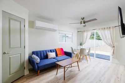 a living room with a blue couch and a table at Cozy and Quiet Front House in Fontana