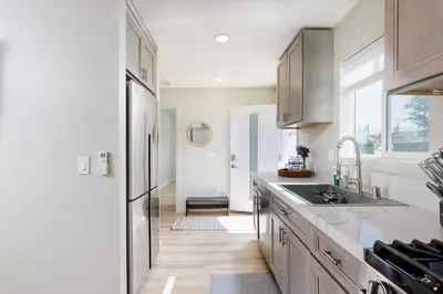 a kitchen with a sink and a refrigerator at Cozy and Quiet Front House in Fontana