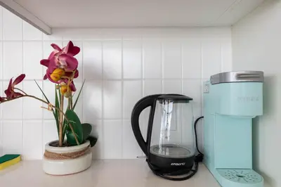 a blender sitting on a counter next to a flower at Spacious 3Bedroom Apt close to LAX & Sofi Stadium* in Los Angeles