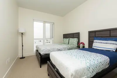 a bedroom with two beds and a window at Spacious 3Bedroom Apt close to LAX & Sofi Stadium* in Los Angeles