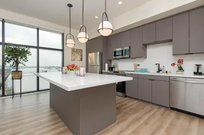 a kitchen with a large white counter top and large windows at Spacious 3Bedroom Apt close to LAX & Sofi Stadium* in Los Angeles