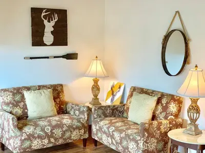 a living room with two couches and a mirror at Beautiful Lake View House for rent! in Lake Arrowhead