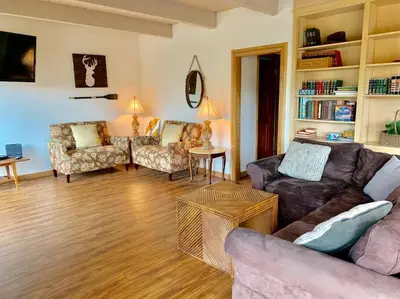 a living room with a couch and chairs and a table at Beautiful Lake View House for rent! in Lake Arrowhead