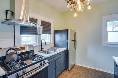 a kitchen with a stove and a stainless steel refrigerator at 1 Mi to Dtwn! Bright Long Beach Apartment in Long Beach
