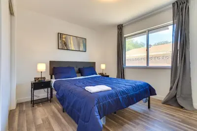a bedroom with a blue bed and a window at Quiet Ridgecrest Vacation Rental with Private Yard! in Ridgecrest
