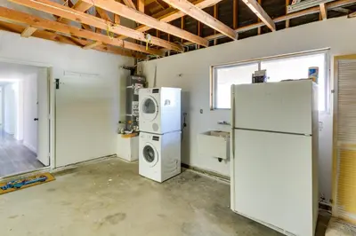 a laundry room with a refrigerator and washer and dryer at Quiet Ridgecrest Vacation Rental with Private Yard! in Ridgecrest