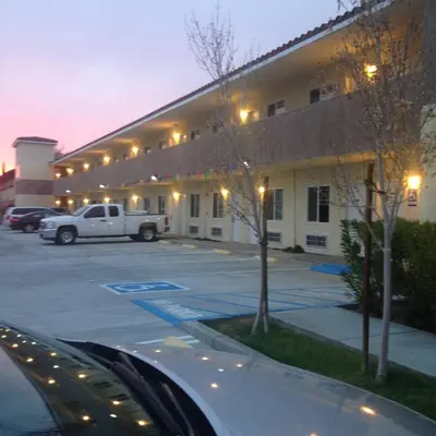 a white truck parked in front of a building at America Inn & Suites in Ridgecrest