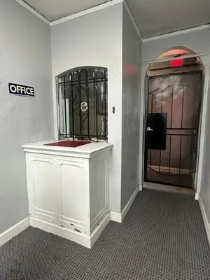 a bathroom with a white cabinet and a door with a mirror at Unity Hotel - No Parking & Rooms Are Upstairs in Long Beach