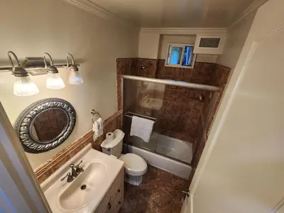 a bathroom with a sink and a toilet and a mirror at Hollywood Hills Hideout Apartment! in Los Angeles