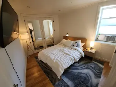 a bedroom with a large bed and a large mirror at Hollywood Hills Hideout Apartment! in Los Angeles