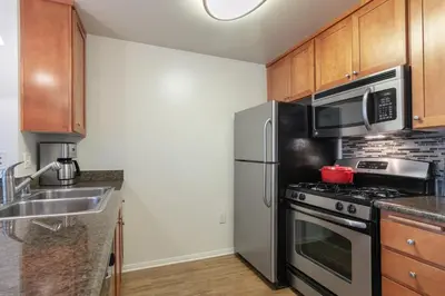 a kitchen with a stainless steel refrigerator and microwave at Playa del Rey 1BR w Gym WD Pool nr LAX Beach LAX-147 in Los Angeles