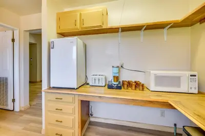 a kitchen with a counter with a refrigerator and a microwave at Tranquil Maricopa Retreat with Pool and Hot Tub in Maricopa