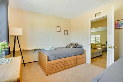 a bedroom with a bed and a living room at Tranquil Maricopa Retreat with Pool and Hot Tub in Maricopa