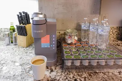 a coffee maker and a tray of cupcakes and water bottles at Luxurious Hollywood Dream in Los Angeles