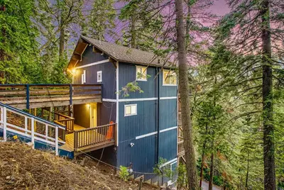 a blue tiny house in the woods at Tree-Lined Lake Arrowhead Cabin about 1 Mi to Village! in Lake Arrowhead
