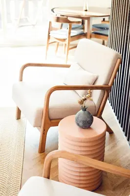 a living room with a chair and a table at Modern Designer Cabin, Newly Renovated, EV Charger, Arcade, Kids Bunkbed, Minutes to Lake Arrowhead and Lake Gregory in Twin Peaks