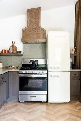 a kitchen with a stove and a white refrigerator at Modern Designer Cabin, Newly Renovated, EV Charger, Arcade, Kids Bunkbed, Minutes to Lake Arrowhead and Lake Gregory in Twin Peaks