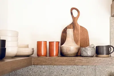 a shelf with different types of bowls and vases at Modern Designer Cabin, Newly Renovated, EV Charger, Arcade, Kids Bunkbed, Minutes to Lake Arrowhead and Lake Gregory in Twin Peaks