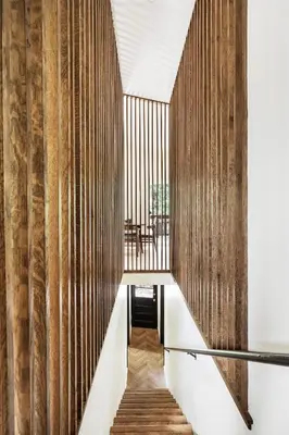 a hallway with wood paneled walls and a staircase at Modern Designer Cabin, Newly Renovated, EV Charger, Arcade, Kids Bunkbed, Minutes to Lake Arrowhead and Lake Gregory in Twin Peaks
