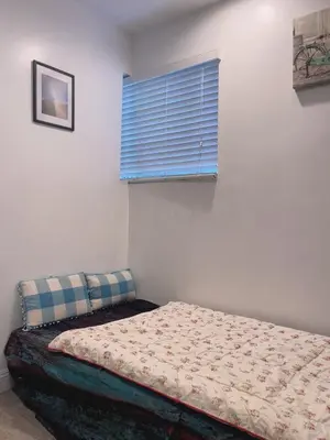 a bedroom with a bed with a blue window at cozy & Quiet Tow Bed & one bath in Rosemead
