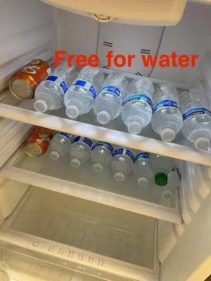 a refrigerator filled with lots of water bottles at cozy & Quiet Tow Bed & one bath in Rosemead