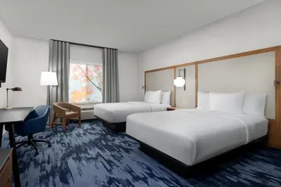 a hotel room with two beds and a desk at Fairfield Inn & Suites Riverside Corona/Norco in Norco