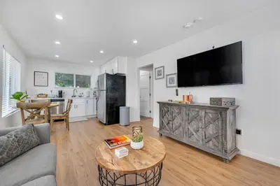 a living room with a couch and a table at Modern Cottage, Hot Tub, Bistro Patio, Putting Green, Walk to All! in Thousand Oaks