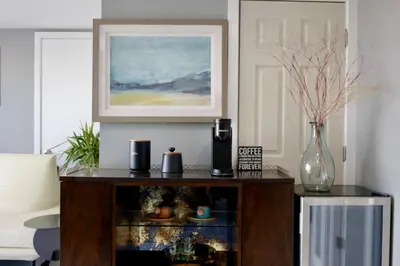 a living room with a table with a vase of flowers at Vista Bliss Retreat-Private Room in Los Angeles